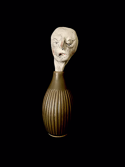 Head sculpture emerging from a ceramic pot