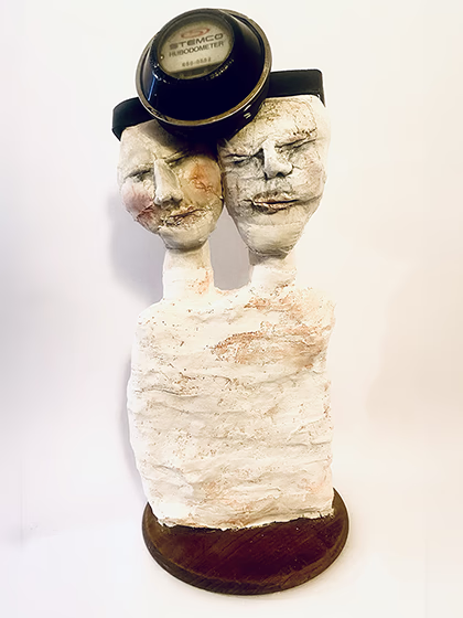 Double headed skeletal torso crowned with a vintage mechanical hubodometer